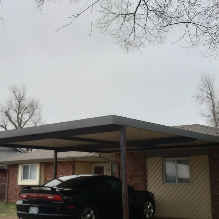 A clear sky above a Norman carport after overhanging limbs were removed
